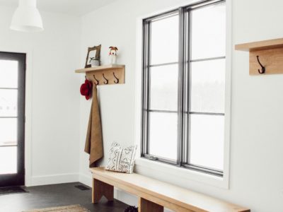 A muti-functional laundry room/mudroom doesn't have to be boring! This room provides lots of hanging space for coats, a beautiful oak bench tying into the oak accents of the home with herringbone patterned tile